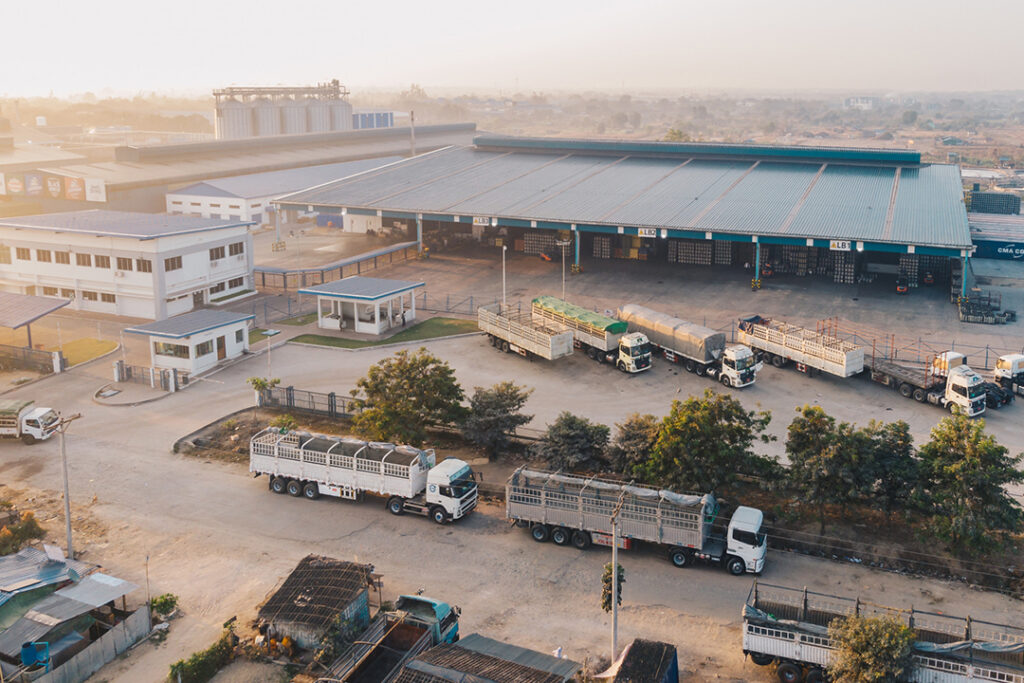 An aerial view of a logistics depot with trucks parked outside.