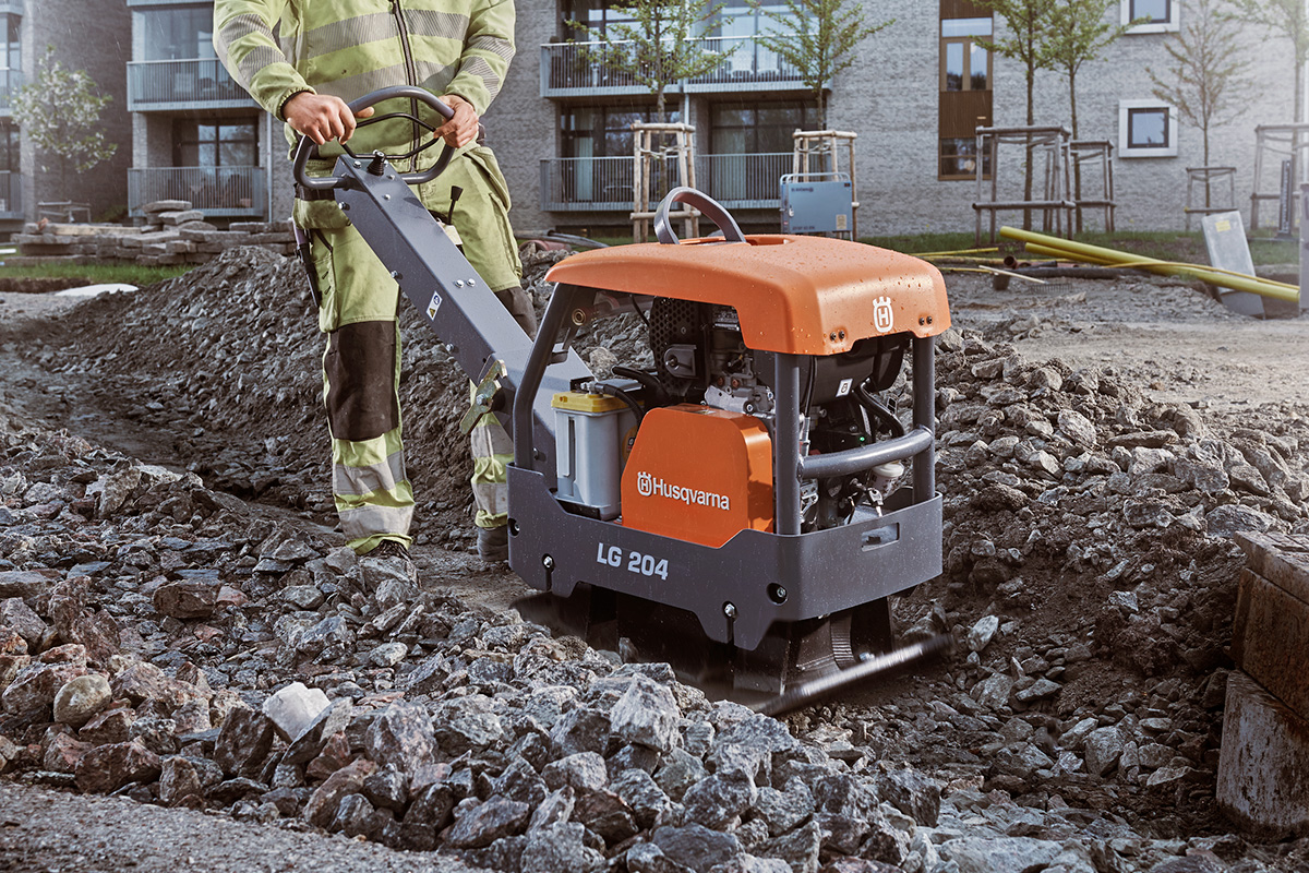 A Husqvarna LG 204 plat compaction machine on rough rocks.