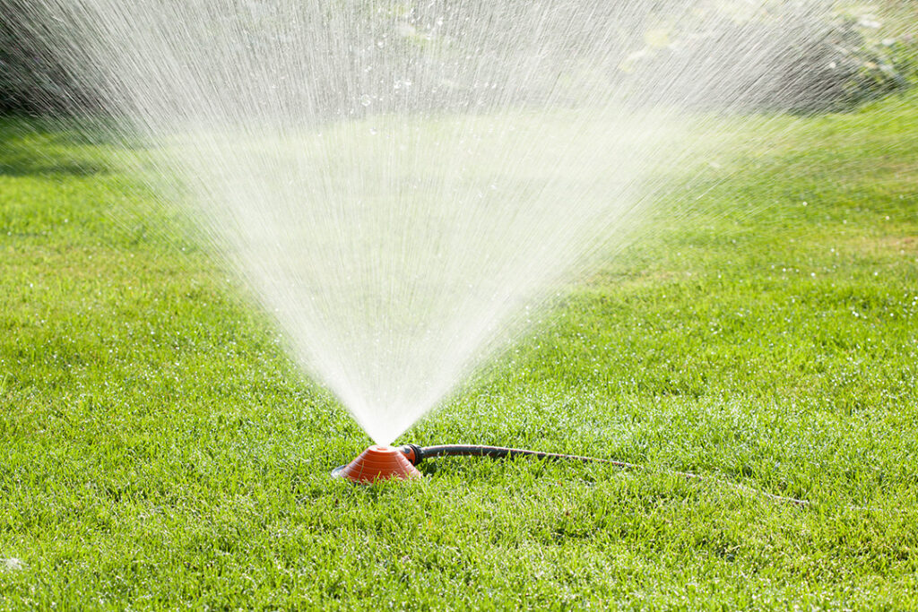 A GARDENA Pyramid Sprinkler on a green lawn