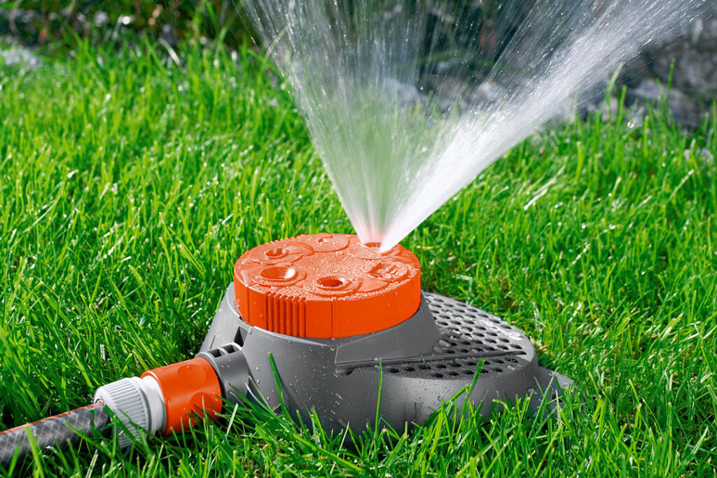 A GARDENA Six Pattern Boogie Spray on a green lawn.