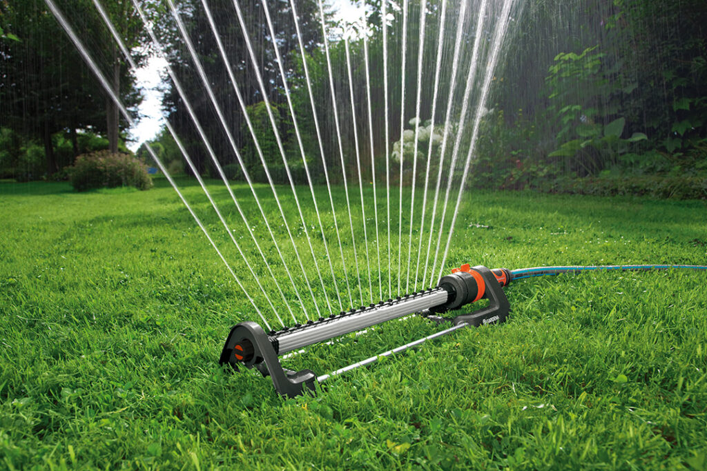 A GARDENA Oscillating Sprinkler on a green lawn.